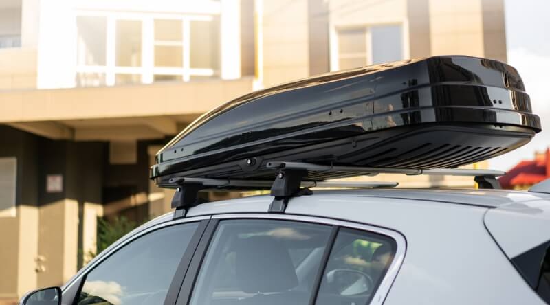 Silver car equipped with a black roof box