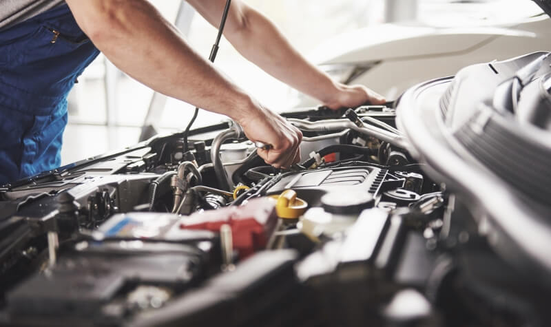 Auto mechanic performing maintenance on a car