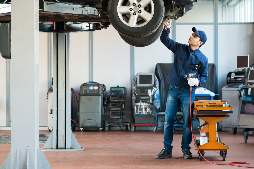 mechanic inspecting car