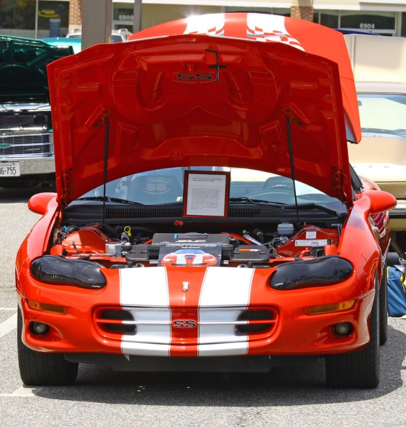 Red Chevrolet Camaro with white stripes