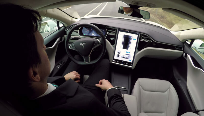 Self-driving Tesla car on a road