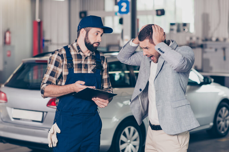 Auto mechanics metionong the high cost of repairs to a client