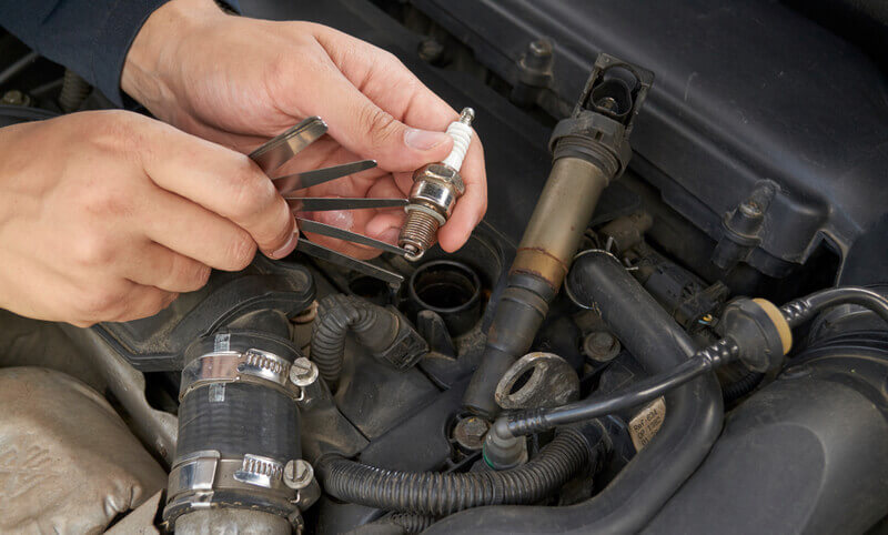 gapping a spark plug with a blade tool