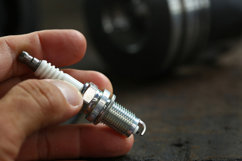 man handles a spark plug